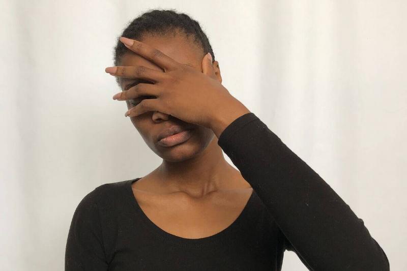 woman putting her hand over her face
