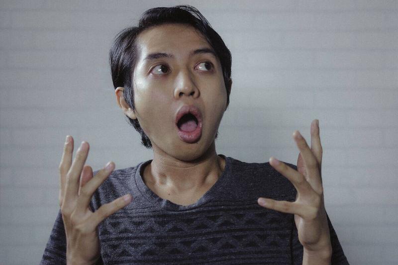 woman with short hair expressing shock