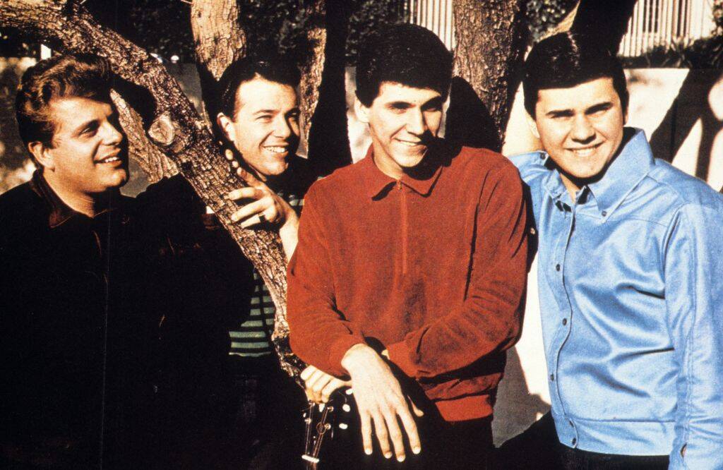 band posing by a tree