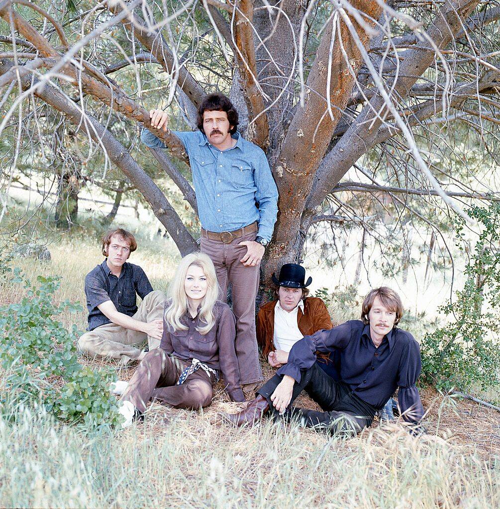 band sitting by a tree