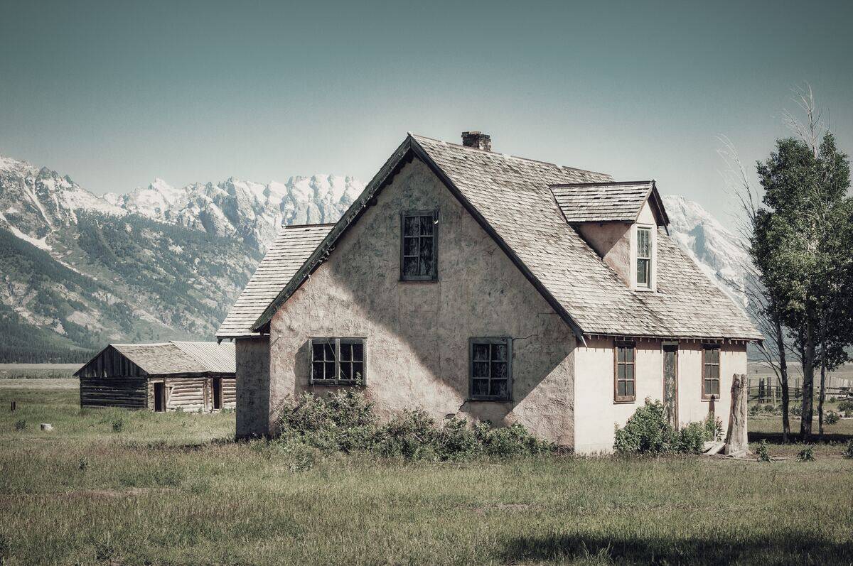 wyoming exterior house by mountains and grass field