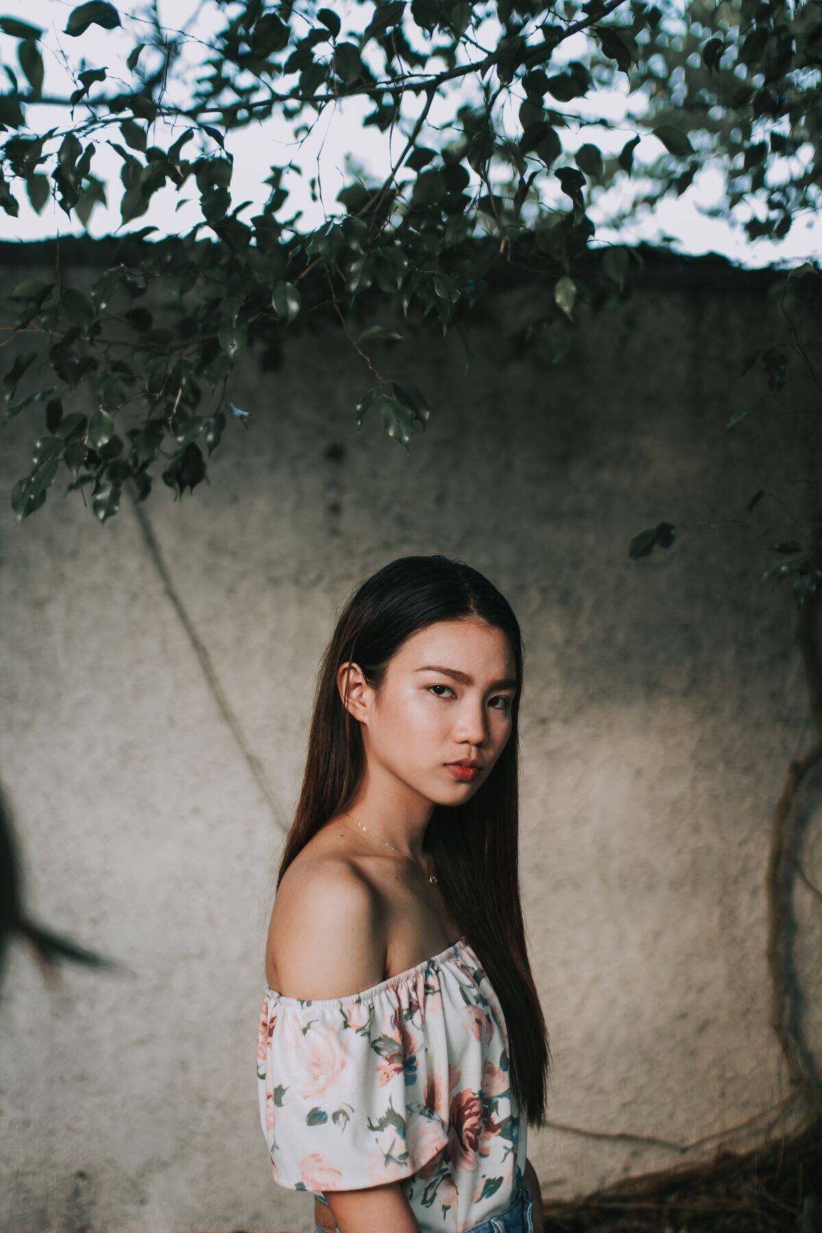 young woman looking angry under plants