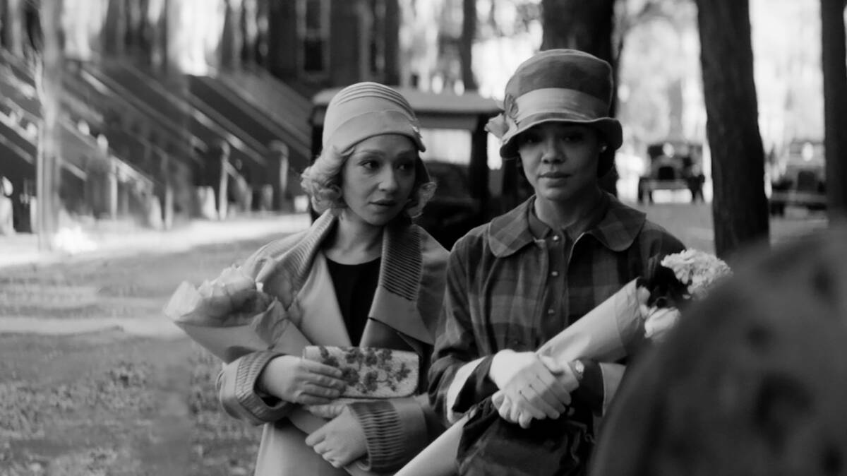 Ruth Negga and Tessa Thompson walk down the street in Passing