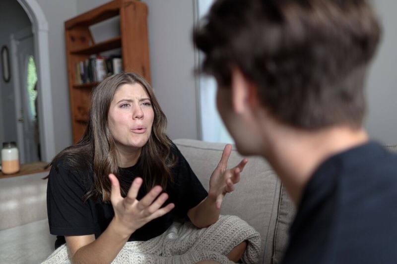 Woman angrily talking to man with bewilderment
