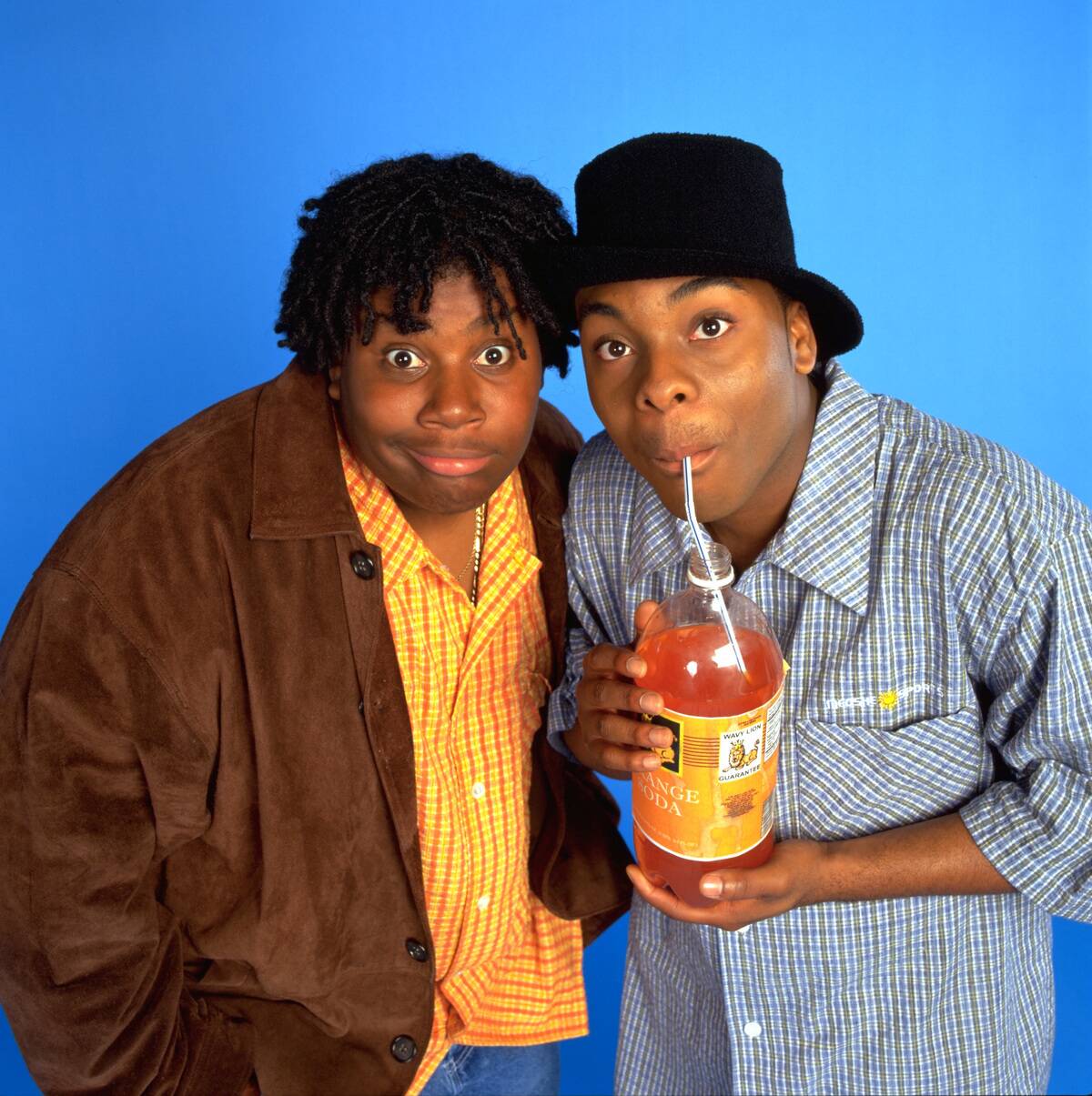 kenan & kel blue background drinking orange soda