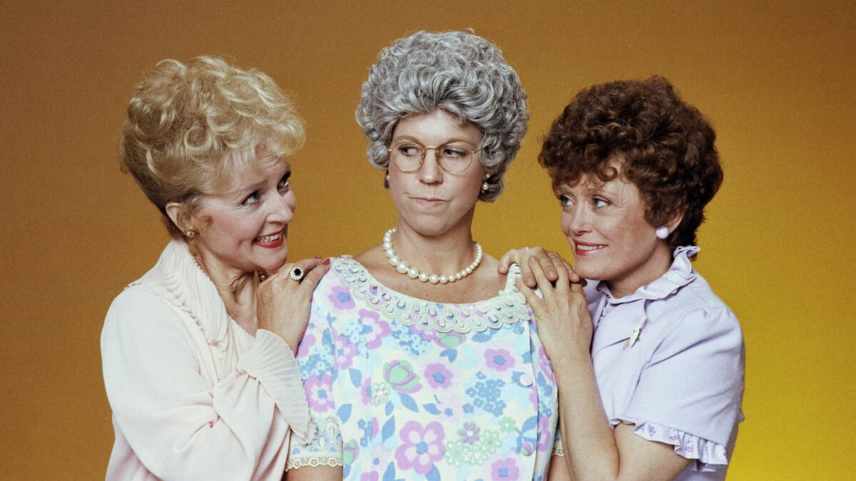 cast of mama's family posing for a photo with gold background