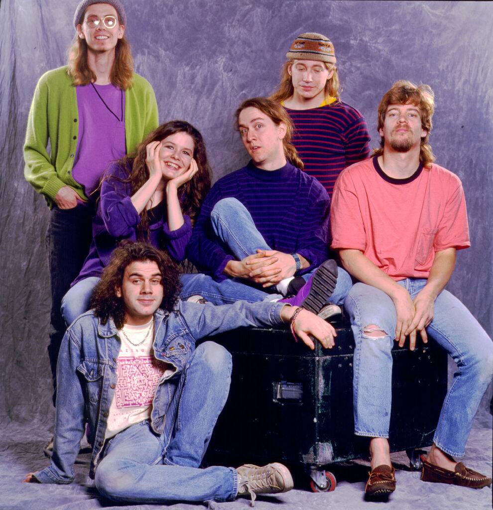 band posing for phot with purple background