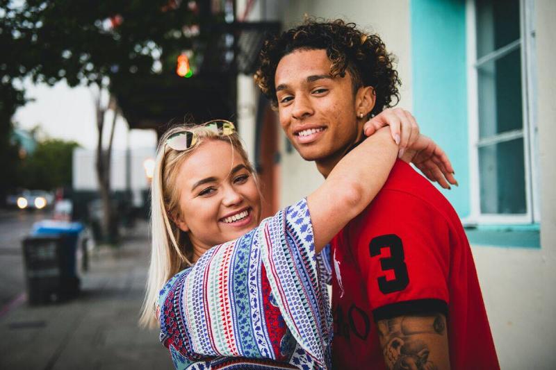 woman with arms around boyfriend's neck