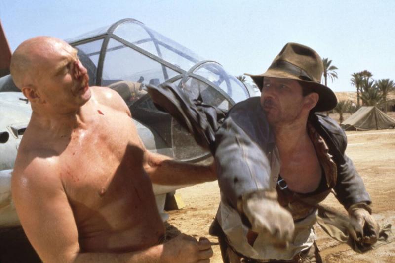 Harrison Ford and Pat Roach stage fighting in Raiders Of The Lost Ark