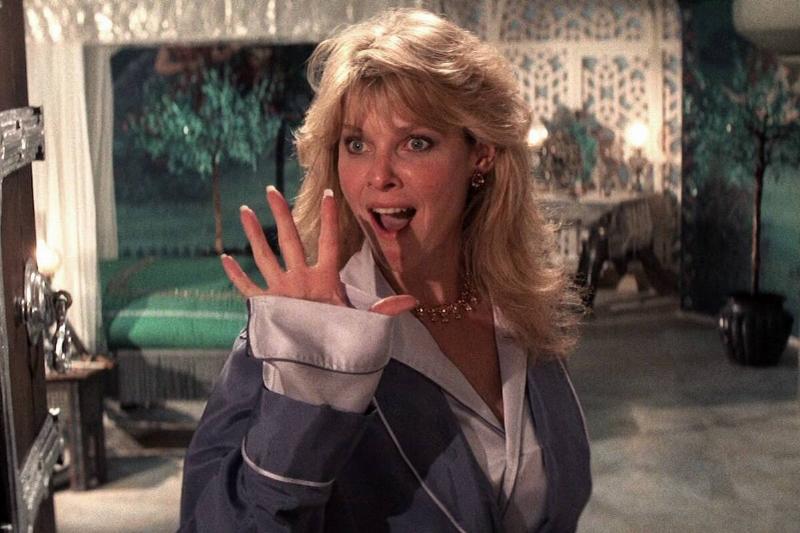 Kate Capshaw holding her hand out as Willie Scott in Indiana Jones and the Temple of Doom