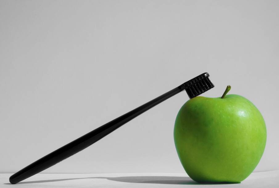 Toothbrush and apple