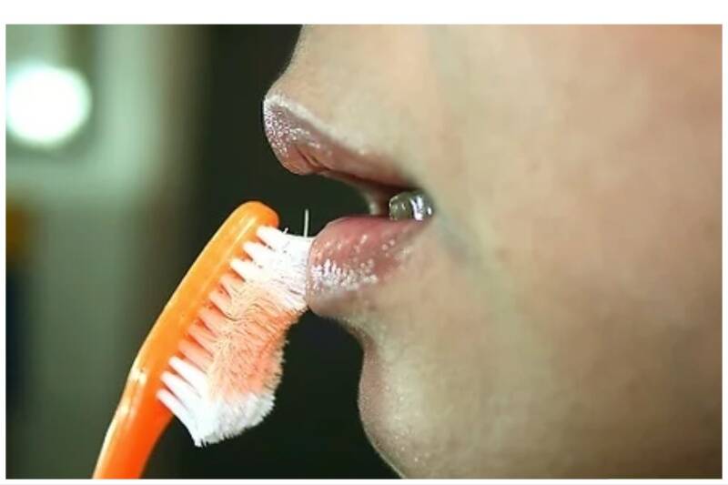 Toothbrush for applying chapstick