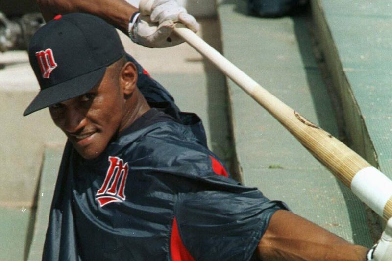 MN TWINS spring Training -- Outfielder Otis Nixon grins at a teammate's joke while taking a break in the dugout during practice Monday.