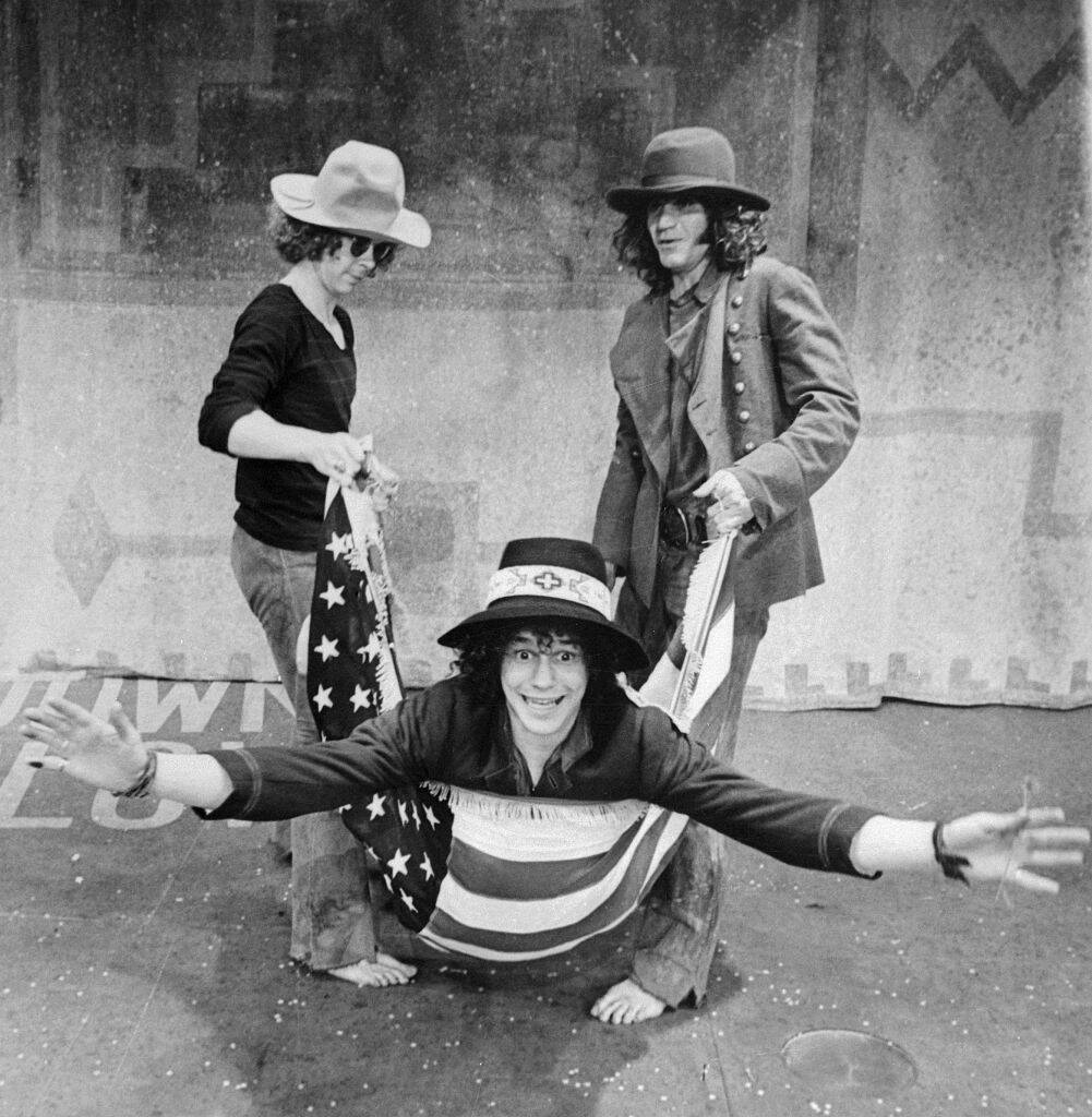 man swinging from an American flag