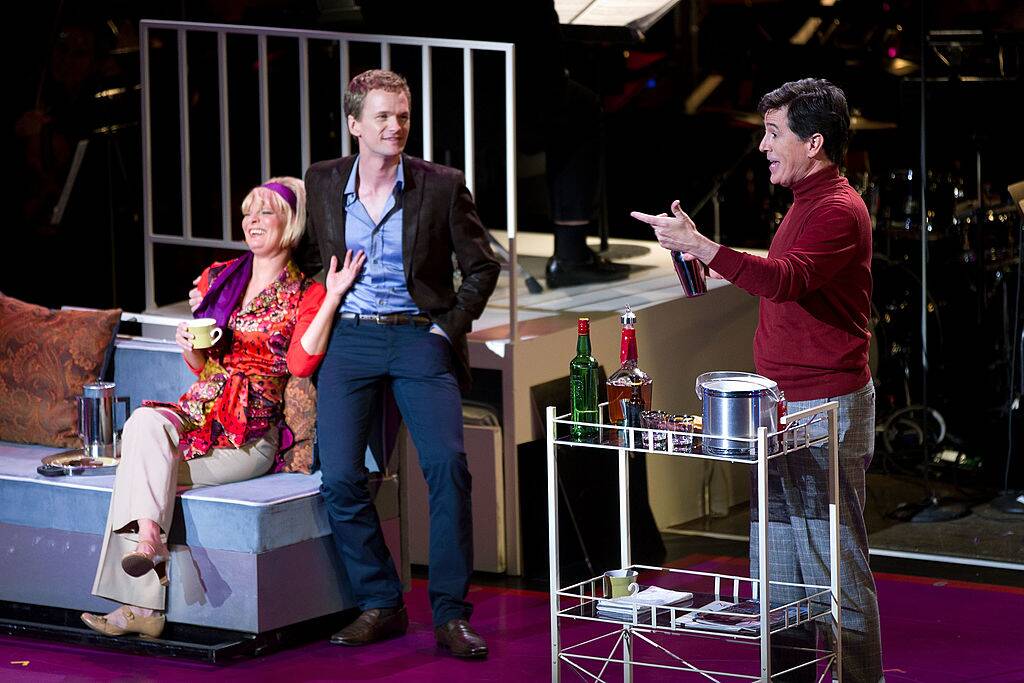 cast performing on stage in a musical