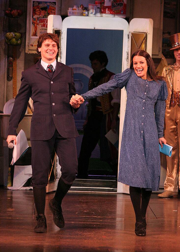 man and woman smiling on stage