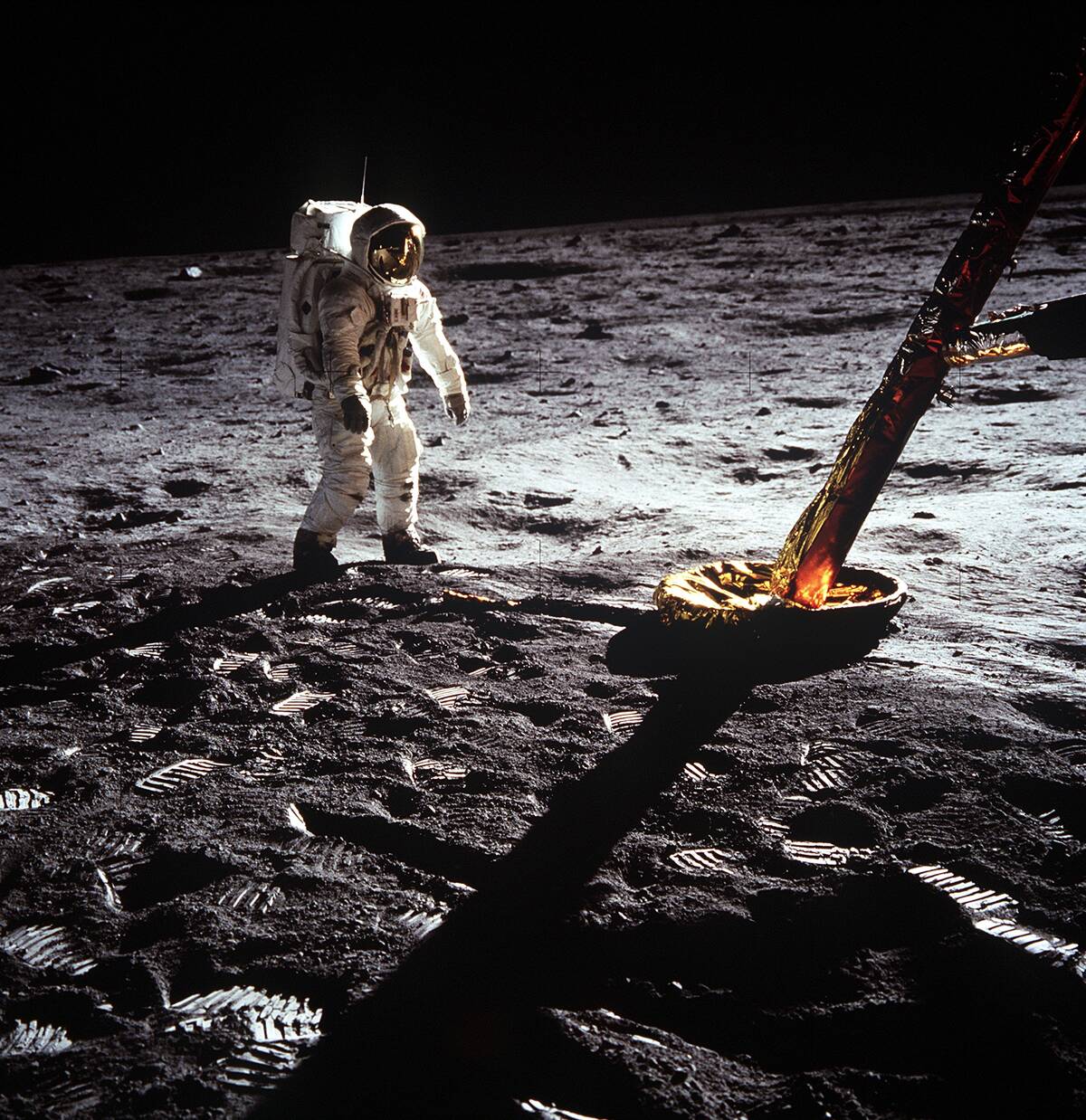 (20 July 1969) Astronaut [redacted], lunar module pilot, walks on the surface of the moon near a leg of the Lunar Module during the Apollo 11 extravehicular activity (EVA).