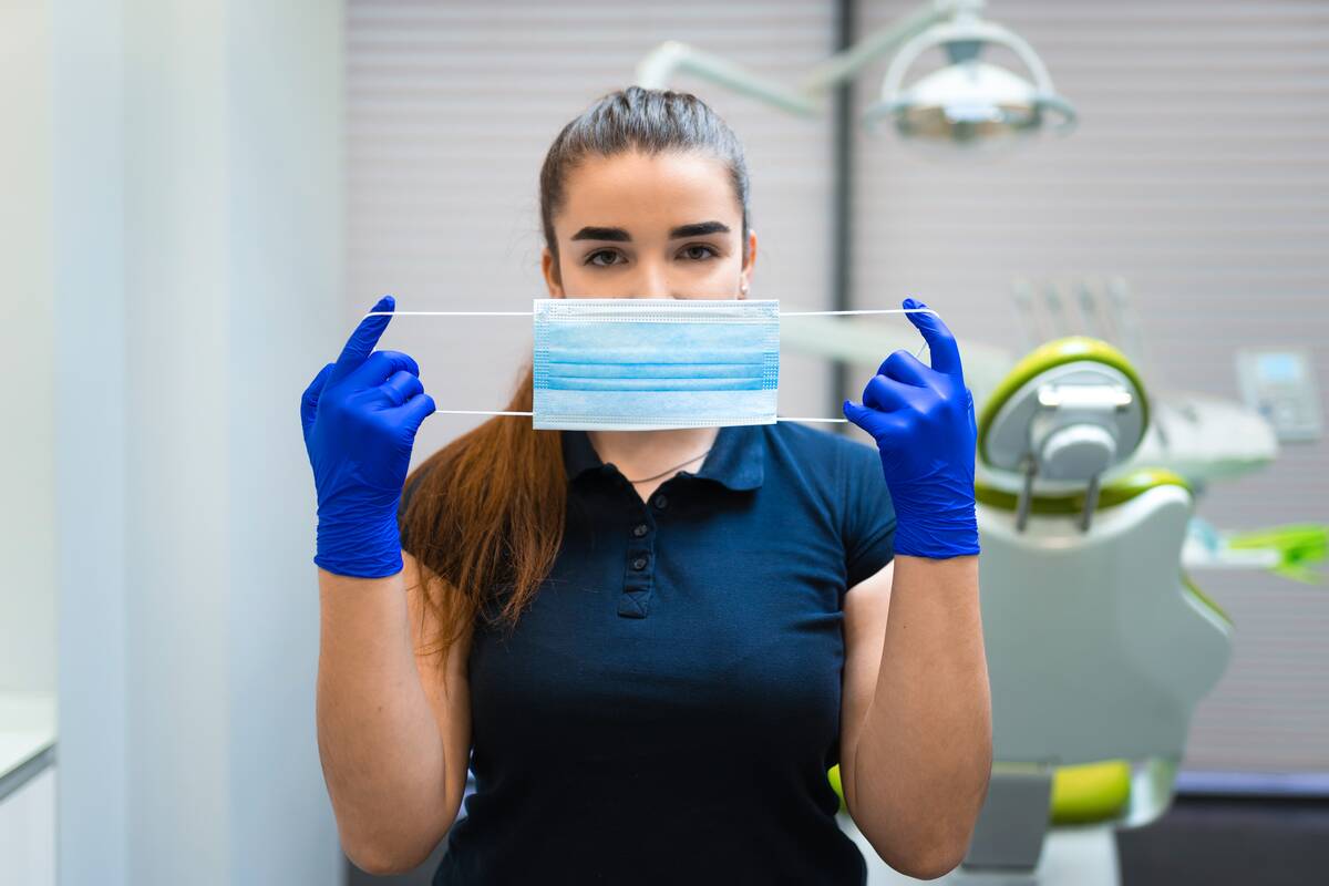 woman holding a surgical mask