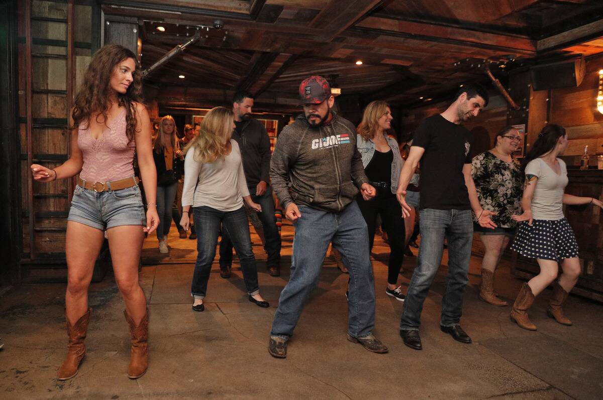 Patrons dance during weekly line dancing lessons at Jaxson, a bar in the Marina that specializes in country music, in San Francisco, Calif., on Sunday, June 24, 2018