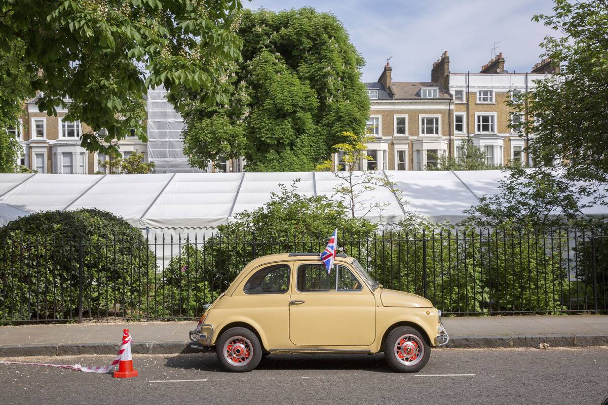 A Stationary Beige Fiat 500 With Union Jack Flag London