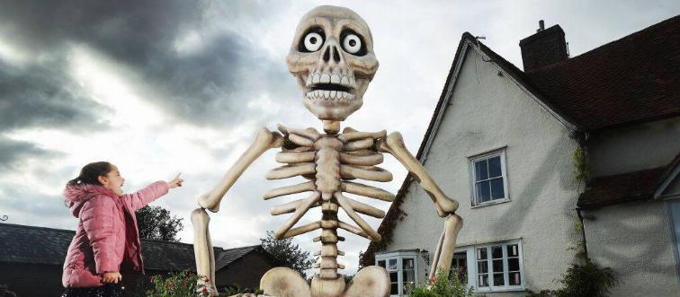 girl looking at giant skeleton