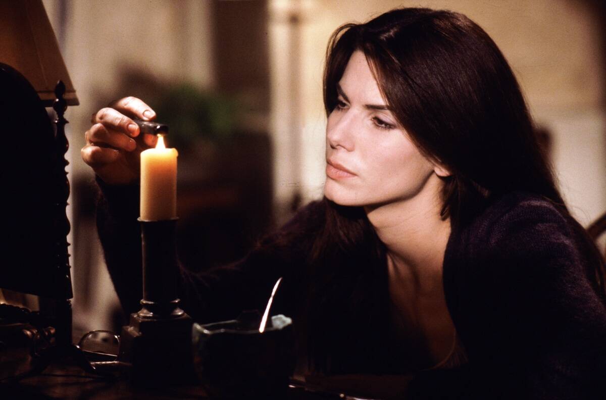 sandra bullock lighting a candle