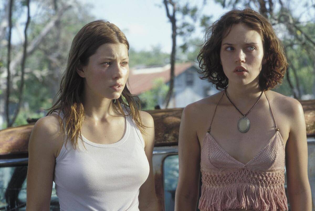 two women wearing tank tops