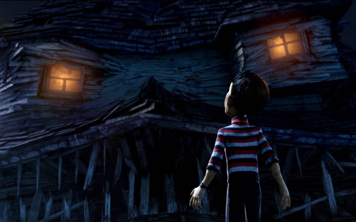 boy standing by a house
