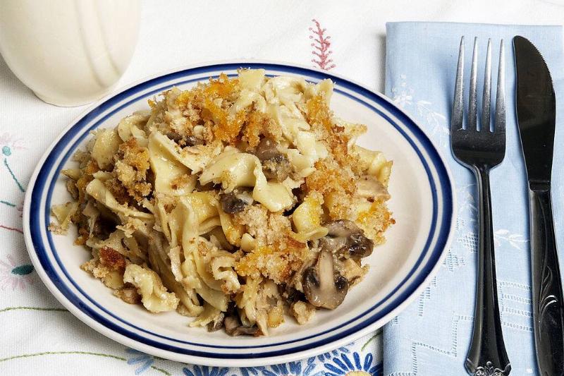 tuna casserole 112869970 Curly pasta and mushrooms add to this tuna casserole along with a topping of grated cheddar and bread crumbs
