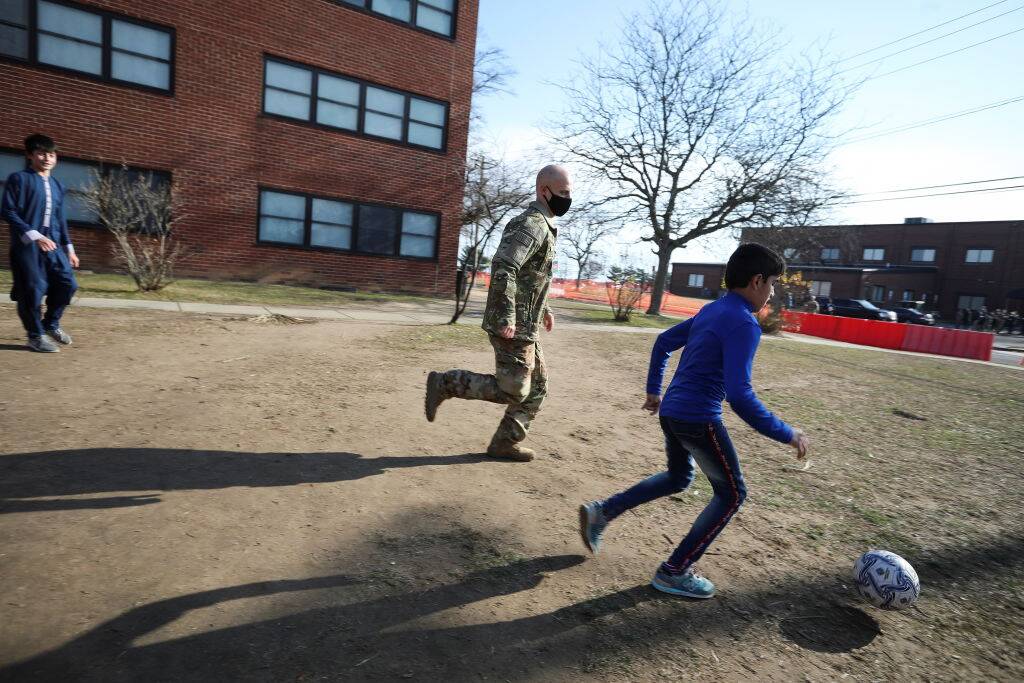 Soldiers playing with kids
