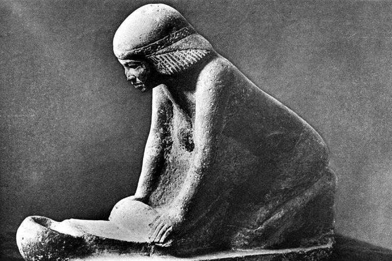 Egyptian tomb figure of a woman grinding corn using a saddle quern, c2500 BC. Egyptian tomb figure of a woman grinding corn using a saddle quern, c2500 BC.