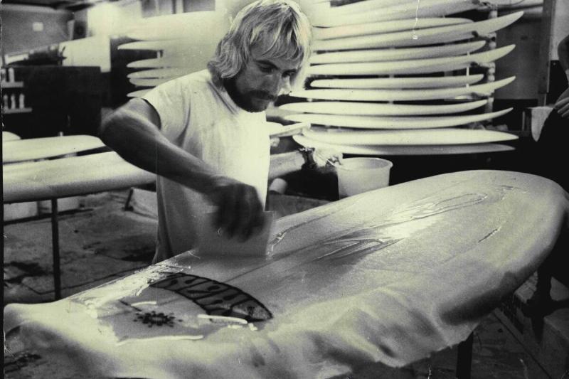 One reason why surfboards cost more than $100. Resin is applied by hand to the fiberglass surrounding the foam core.