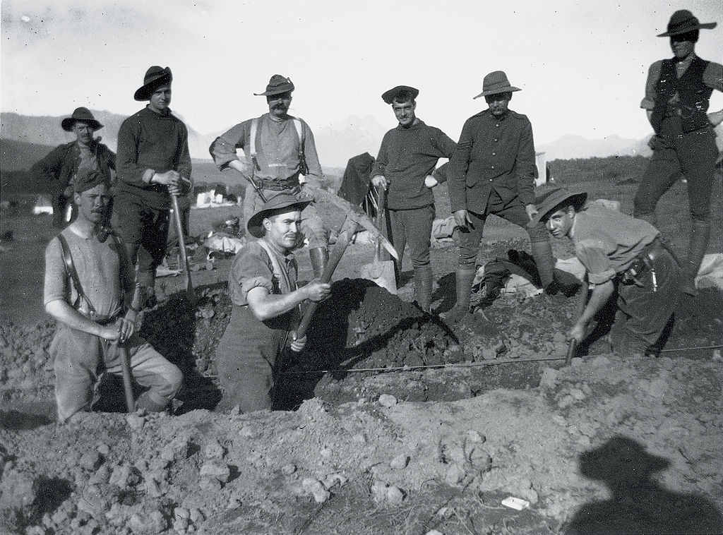 Soldiers using pickaxes to dig a trench for the Boer War