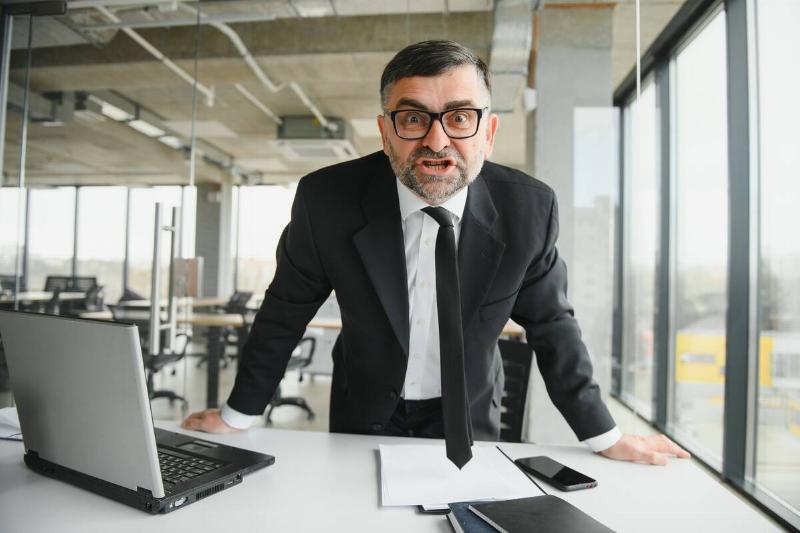 angry-businessman-sitting-at-the-table-and-screami-2024-02-08-16-45-45-utc