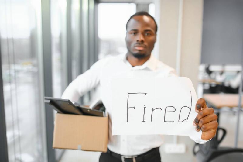 young-african-man-fired-holding-box-with-personal-2024-01-16-18-53-56-utc