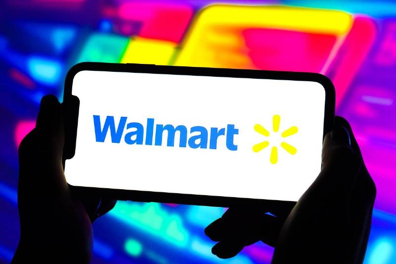 In this photo illustration, a Walmart logo is displayed on...