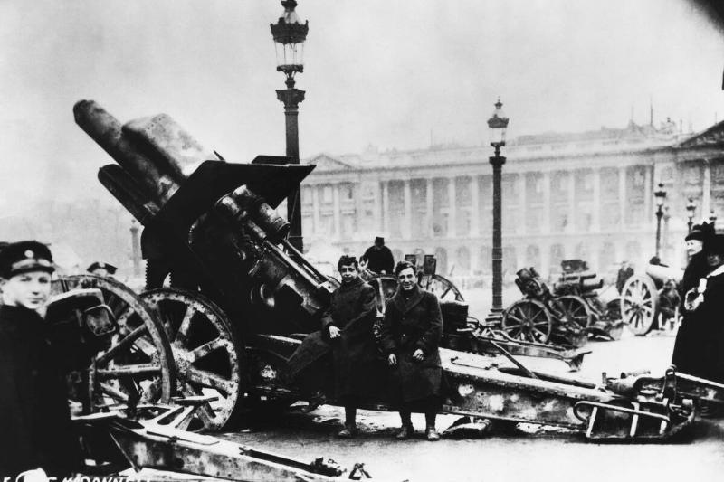 Soldiers Sitting on Big Bertha Artillery Weapon
