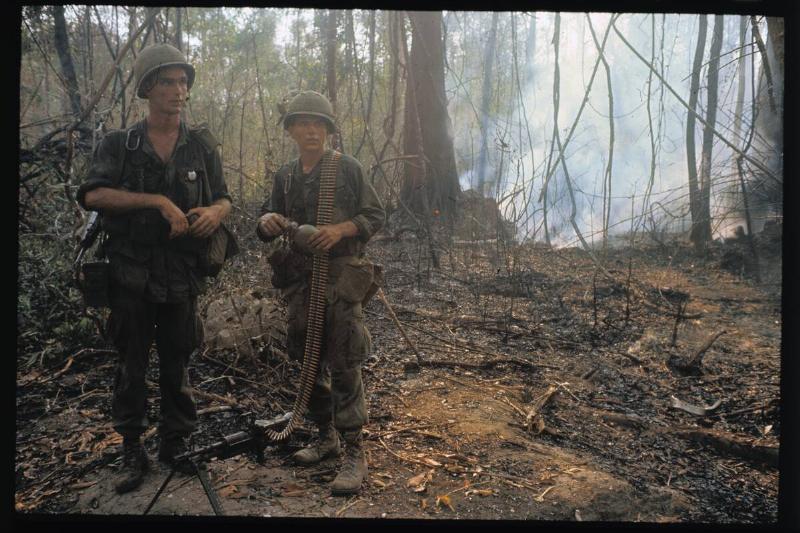 Two Soldiers With Weaponry Standing in Wooded Area
