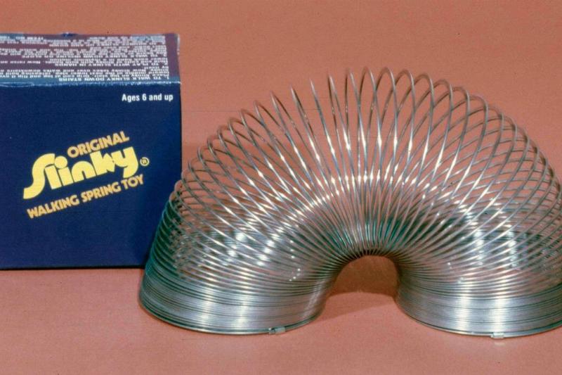 A Slinky is a precompressed helical spring toy invented by Richard James in the early 1940s A Slinky is a precompressed helical spring toy invented by Richard James in the early 1940s