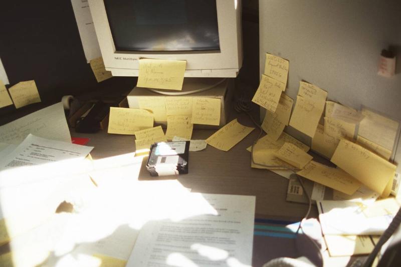 Desk, Computer And Wall Covered With Post-It Notes. Desk, Computer And Wall Covered With Post-It Notes.