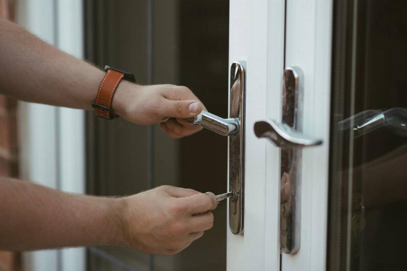 homesecurity3 A person unlocking their door with a key.