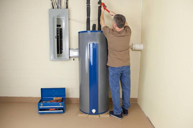 343 Man fixing water heater.