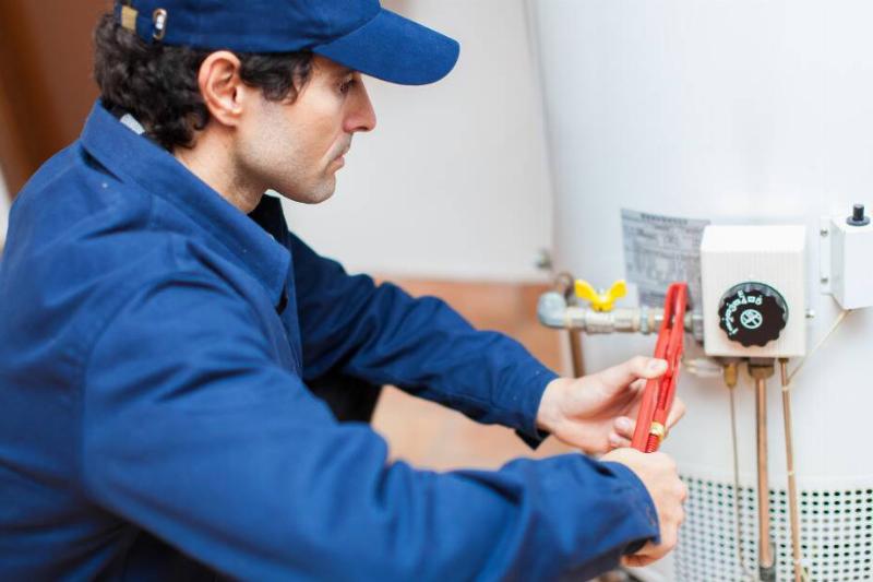 347 Plumber fixing water heater.