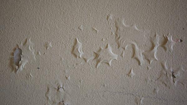 Moisture under paint.