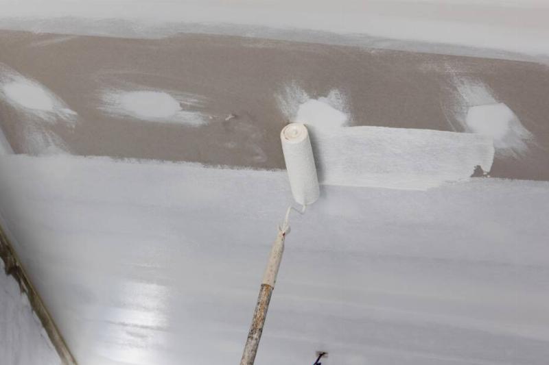 356 Person painting over wall.