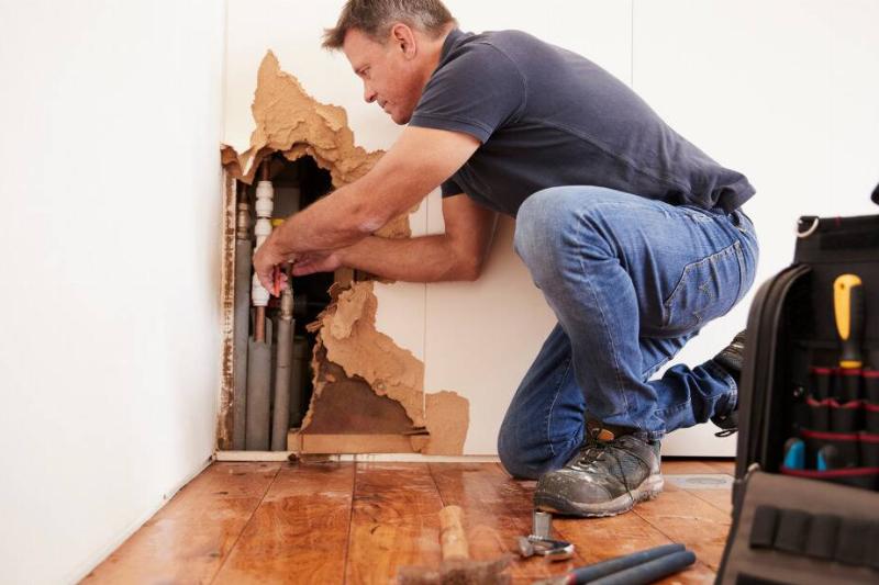 393 Plumber fixing a burst pipe.