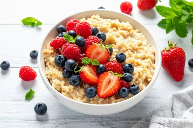 Bowl of oatmeal topped with blueberries, strawberries and raspberries