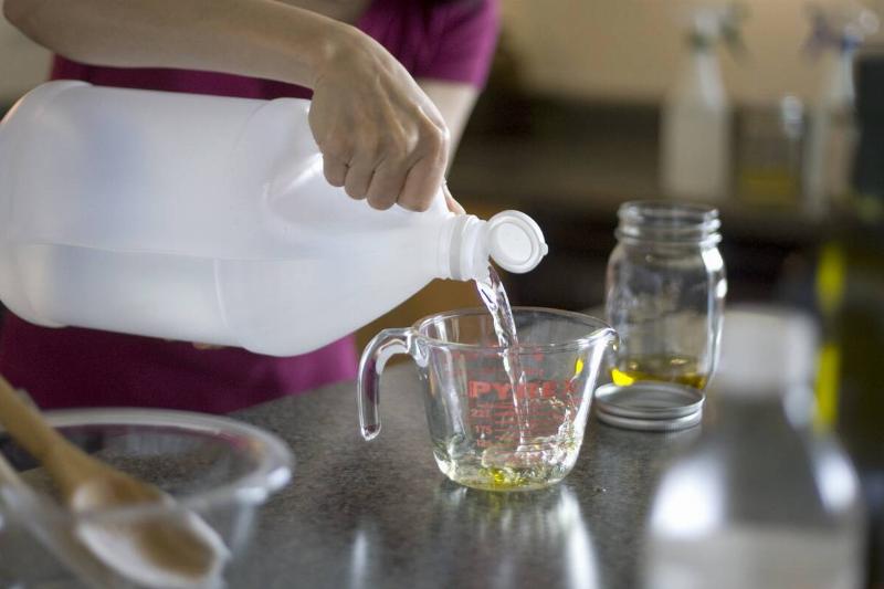 Vinegar bring poured into a measuring cup.