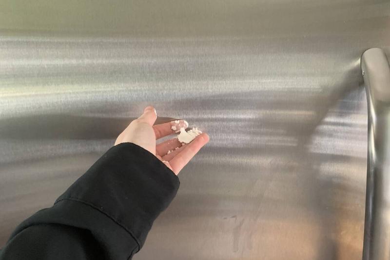 Sprinkling flour on a fridge.