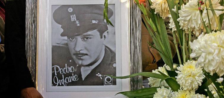 A fan holds a picture of the late Mexica...